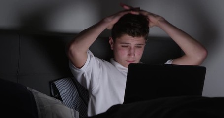 Teenage Victim Of Cyber Bullying Using Laptop 