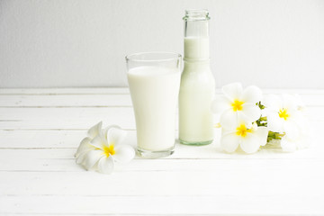 Obraz na płótnie Canvas Milk bottle and milk glass on white wooden background.Drink for health Hi-calcium
