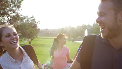 Slow Motion Shot Of Group Of Golfers Walking Along Fairway - Powered by Adobe
