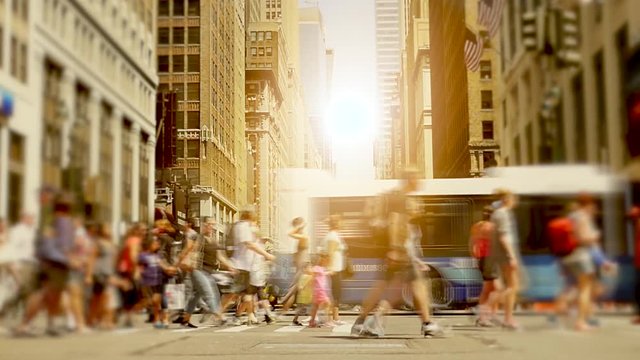 people walking on crowded street in the city. pedestrians commuters background