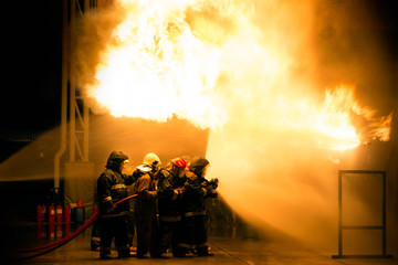 Firefighter Fireman Attack Fire with High Pressure Water