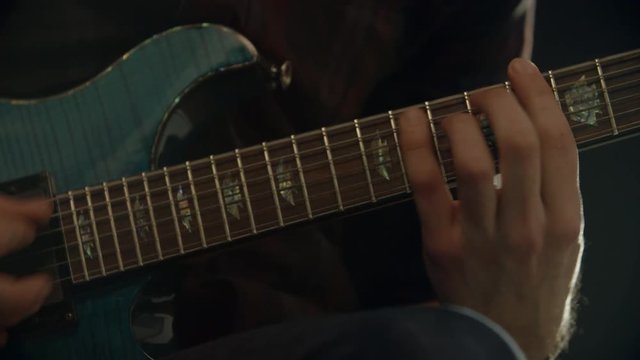 Slow Motion Shot Of Man Playing Electric Guitar