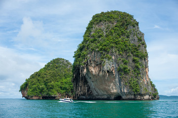 Poda Island, Speed boats and Thai traditional boat anchored in a amazing blue water beach in Krabi,...