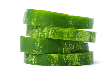 Stack of sliced cucumber on white background