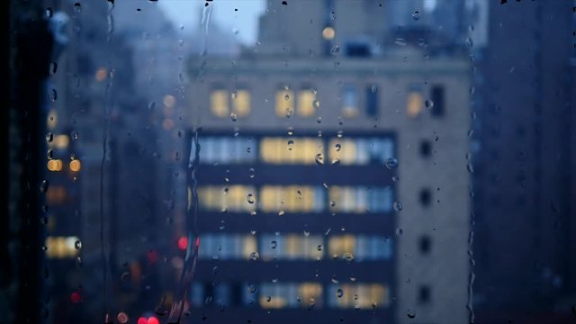 rain pouring down on window glass. bad weather background. snow fall in the city