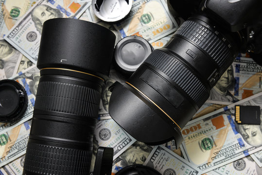 Background American one hundred dollar bills and DSLR camera dev