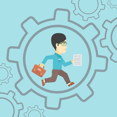 Businessman running inside the gear.