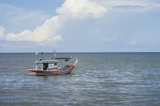 traditional fishing boat laying alone on the sea,selective focus,filtered image
