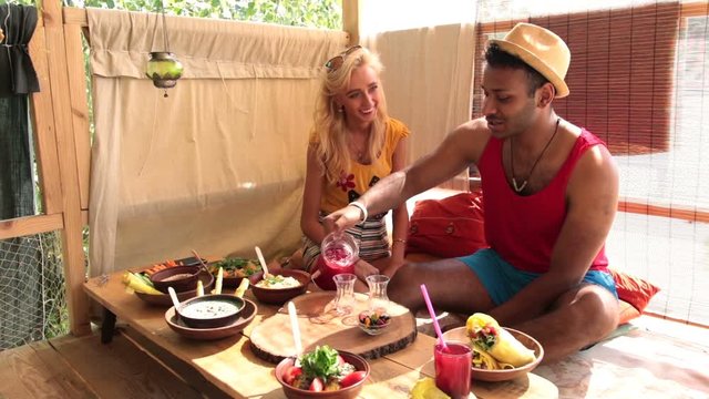 Couple having a lunch on tree house at the beach