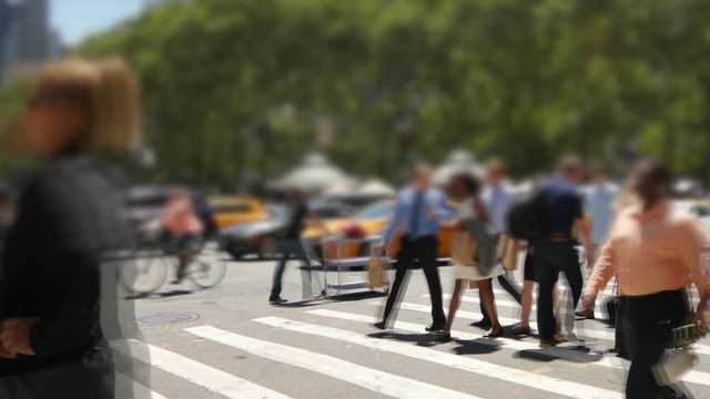 people walking on crowded street in the city. pedestrians commuters background