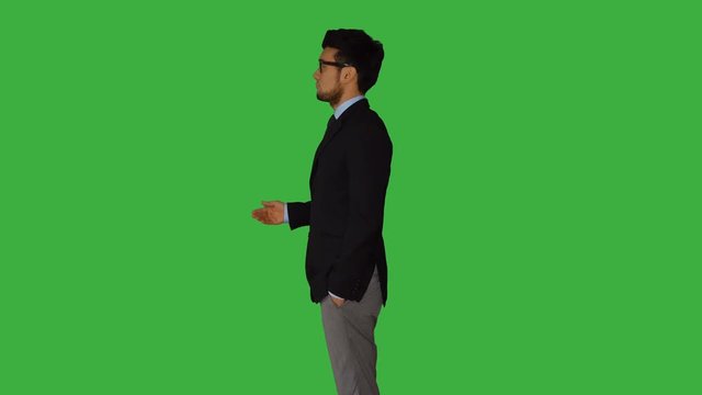 young caucasian man dancing crazy standing against green screen background