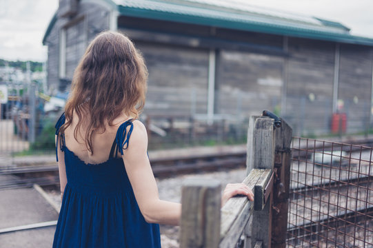 Young woman crossing railroad tracks