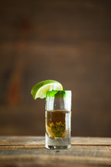 Shot of tequila. Selective focus. Blurred background.