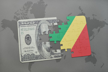 puzzle with the national flag of republic of the congo and dollar banknote on a world map background.