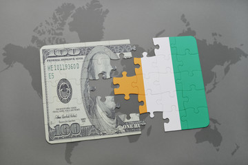 puzzle with the national flag of cote divoire and dollar banknote on a world map background.