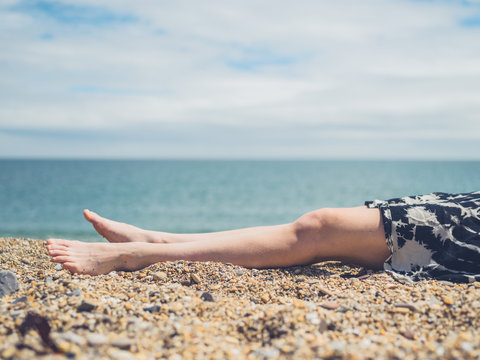 Legs of young woman on the beach