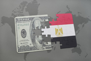 puzzle with the national flag of egypt and dollar banknote on a world map background.