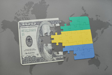 puzzle with the national flag of gabon and dollar banknote on a world map background.