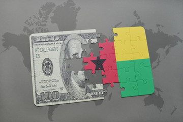 puzzle with the national flag of guinea bissau and dollar banknote on a world map background.