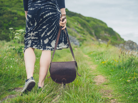 Young woman with handbag in nature