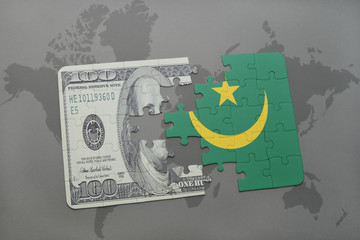 puzzle with the national flag of mauritania and dollar banknote on a world map background.