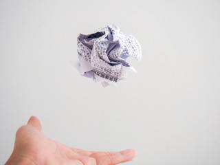 Isolated hand throwing a white paper ball with Japanese text
