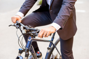 Obraz premium Successful businessman riding bicycle
