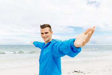 Young man in sport wear with outstretched arms