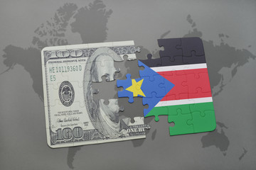 puzzle with the national flag of south sudan and dollar banknote on a world map background.