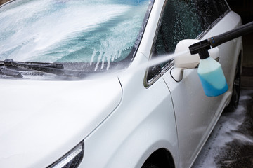 car wash with high pressure water and washing liquid
