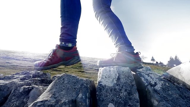 adventure scene of female hiker walking outdoors. foot feet steps