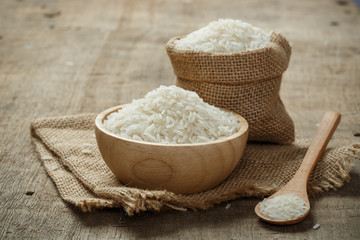 Jasmine Rice in bowl and burlap sack on wooden table