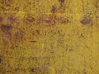 Cracked paint on an old rusty fence