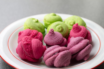 Bright purple, pink and pistachio cakes closeup