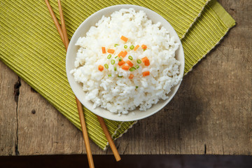 Steamed rice close-up with chopsticks on a fabric mat