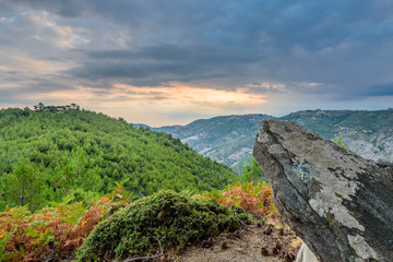 Sun is setting behind dramatic clouds over Thassos Island, Greece - spectacular landscape, shot from a high view point 