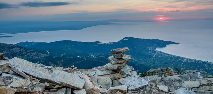 Thassos Island, Greece - view from Mount Ipsarion - little stone pagoda in the middle and first rays of the rising sun