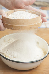 Women's hands preparing flour before baking pie