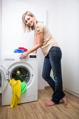 Housework: young woman doing laundry 