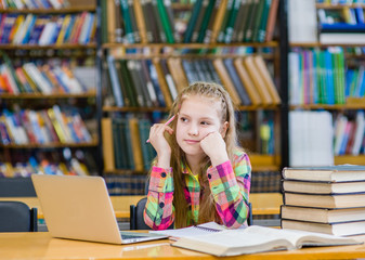 pensive teen girl in a library