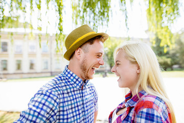 Young happy couple hugging and laughing..beautiful young couple fooling around in the park
