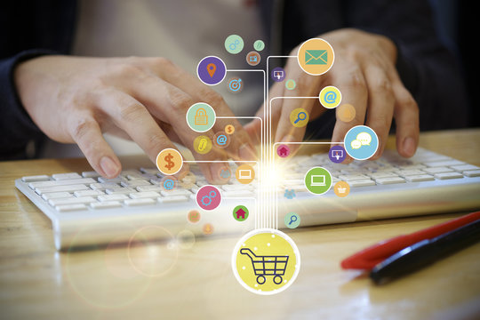 shopping cart with application software icons on key board 