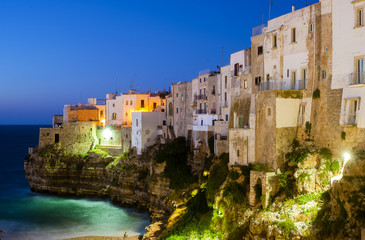 Fototapeta premium Polignano a Mare at night. Sea and rocks. The old town above the sea