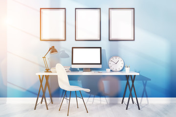 Workplace with modern computer and posters