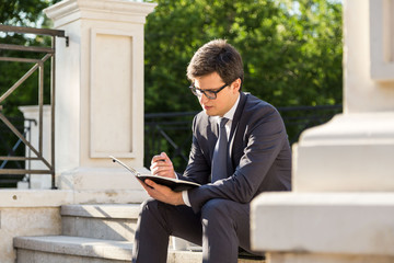 Young businessman making notes