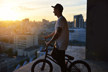 Boy resting with his bmx after practicing in the bowl