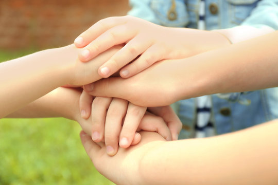 Children holding hands together, closeup