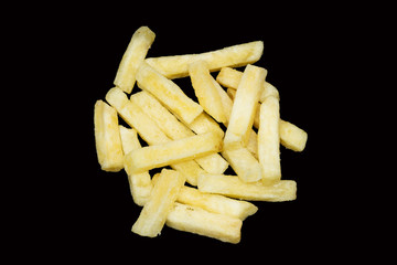 The pile of french fries on the black background.
