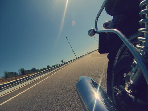 Motorbike backwards indoor camera with bright pipe on a highway