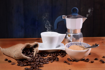 Coffee pot and cup with aromatic coffee and sugar cane
